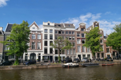 Vacker arkitektur längs kanal i Amsterdam.