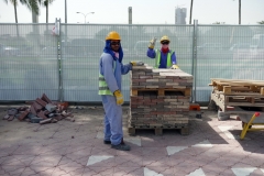 Två arbetare som sliter hårt i solen med renoveringen av the Corniche, Doha.