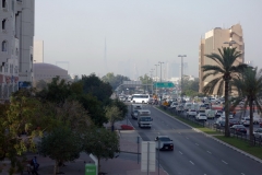 Utsikt från gångbron vid mitt hotell i västlig riktning med Burj Khalifa knappt synlig på grund av smog, Deira, Dubai.